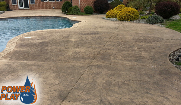 Stamped concrete patio before cleaning, faded and dirty