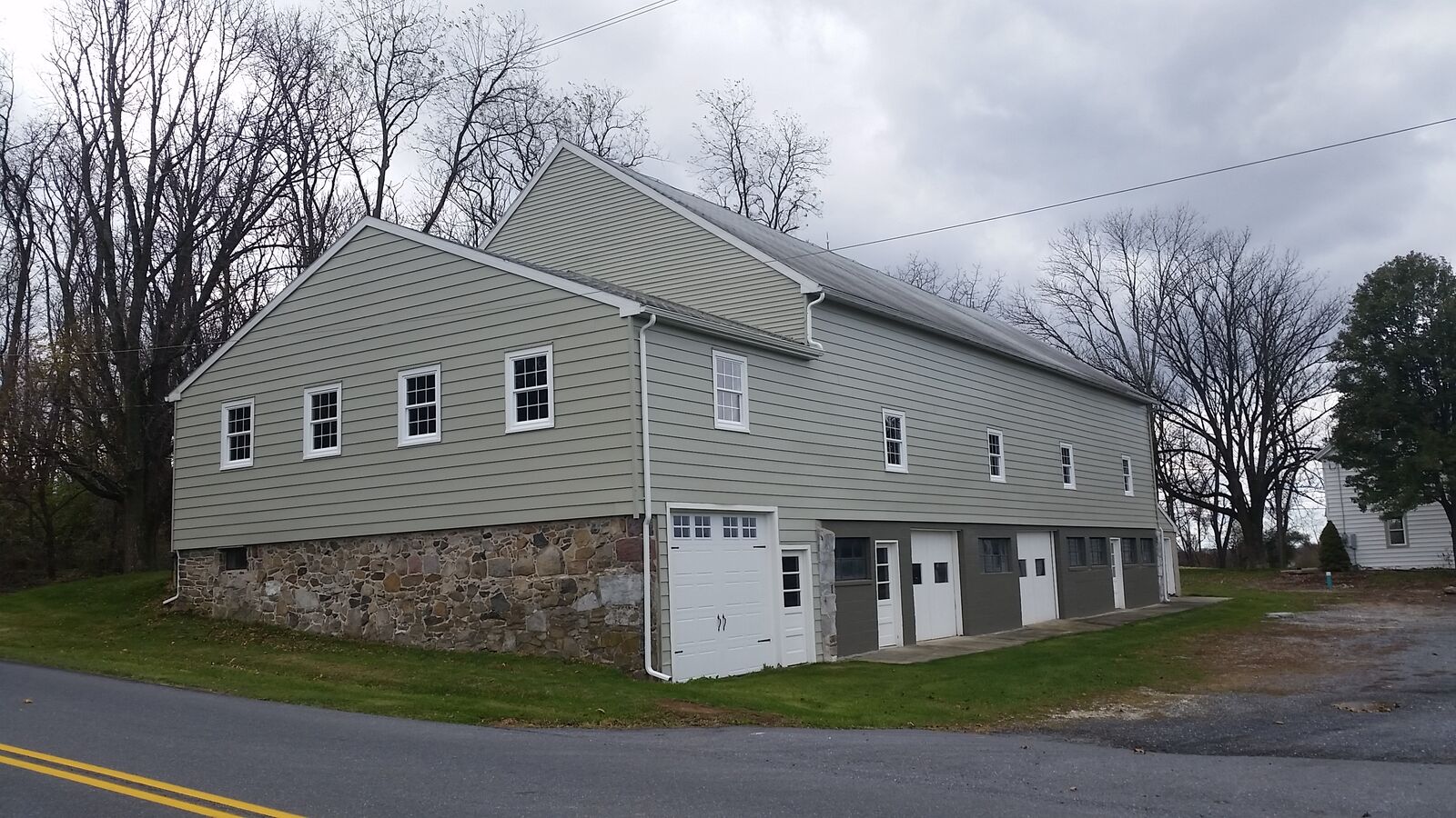 Freshly painted gray siding on a farmhouse in Central PA by Power Play