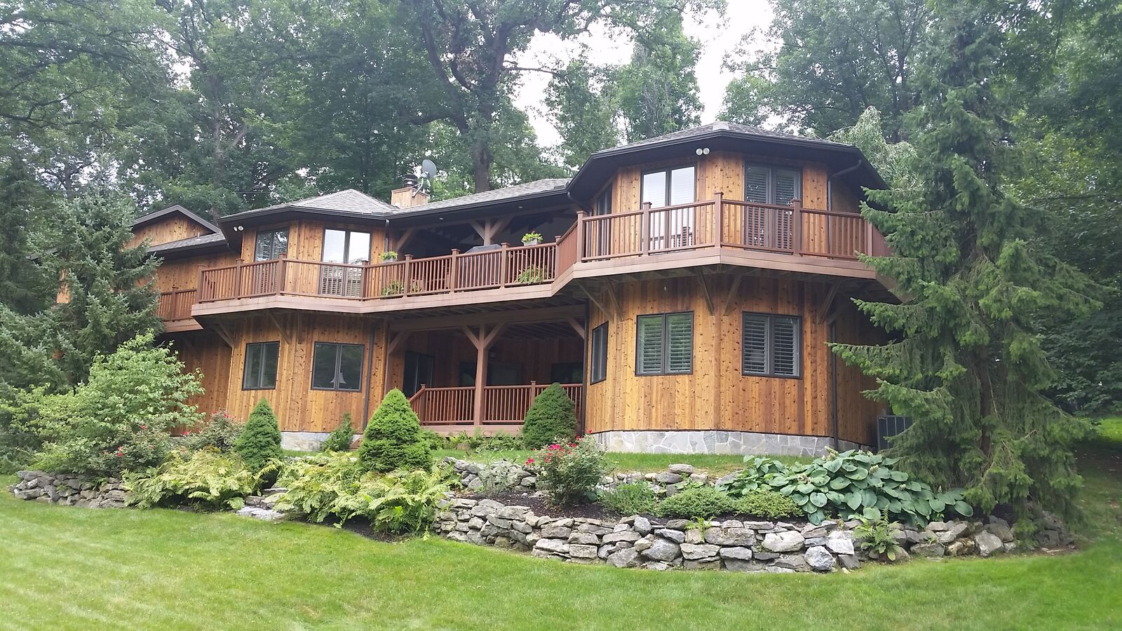 Cedar-sided home with freshly finished exterior and decks