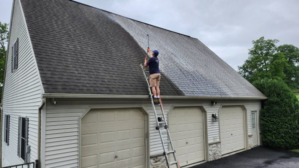 roof-soft-washing-lebanon-pa Power Play technician soft washing a garage roof in Lebanon County, PA